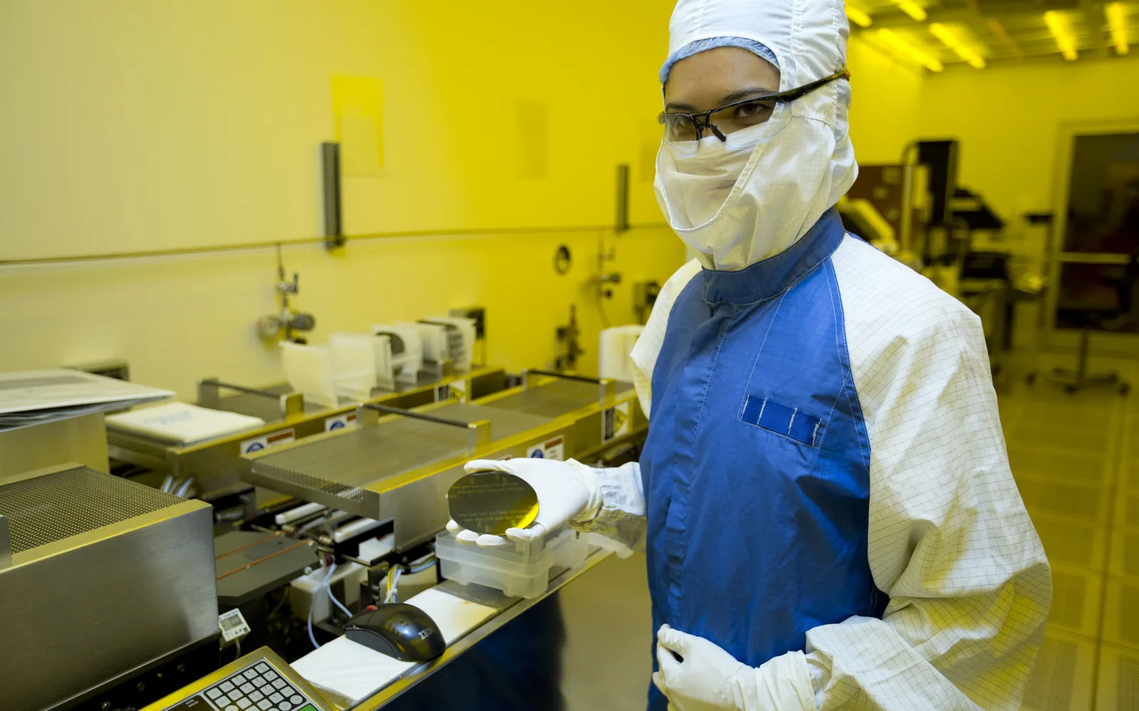 Researcher at Lawrence Livermore National Laboratory examining a silicon wafer in the laboratory
