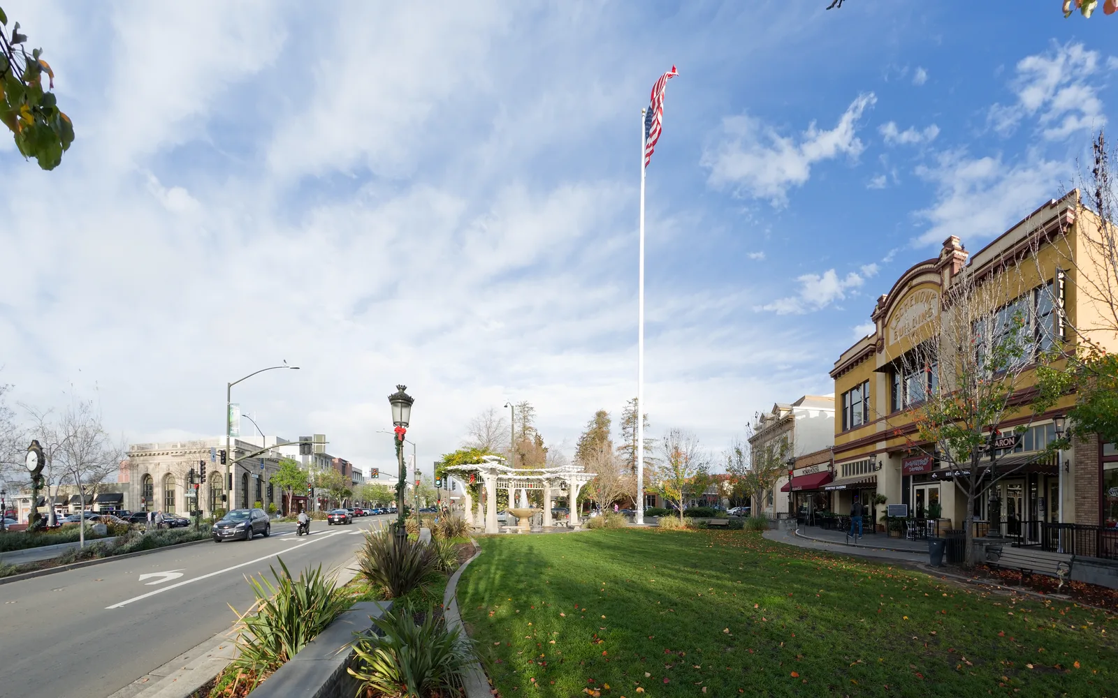 Historic downtown Livermore with clock tower, flagpole, and early 20th century commercial buildings